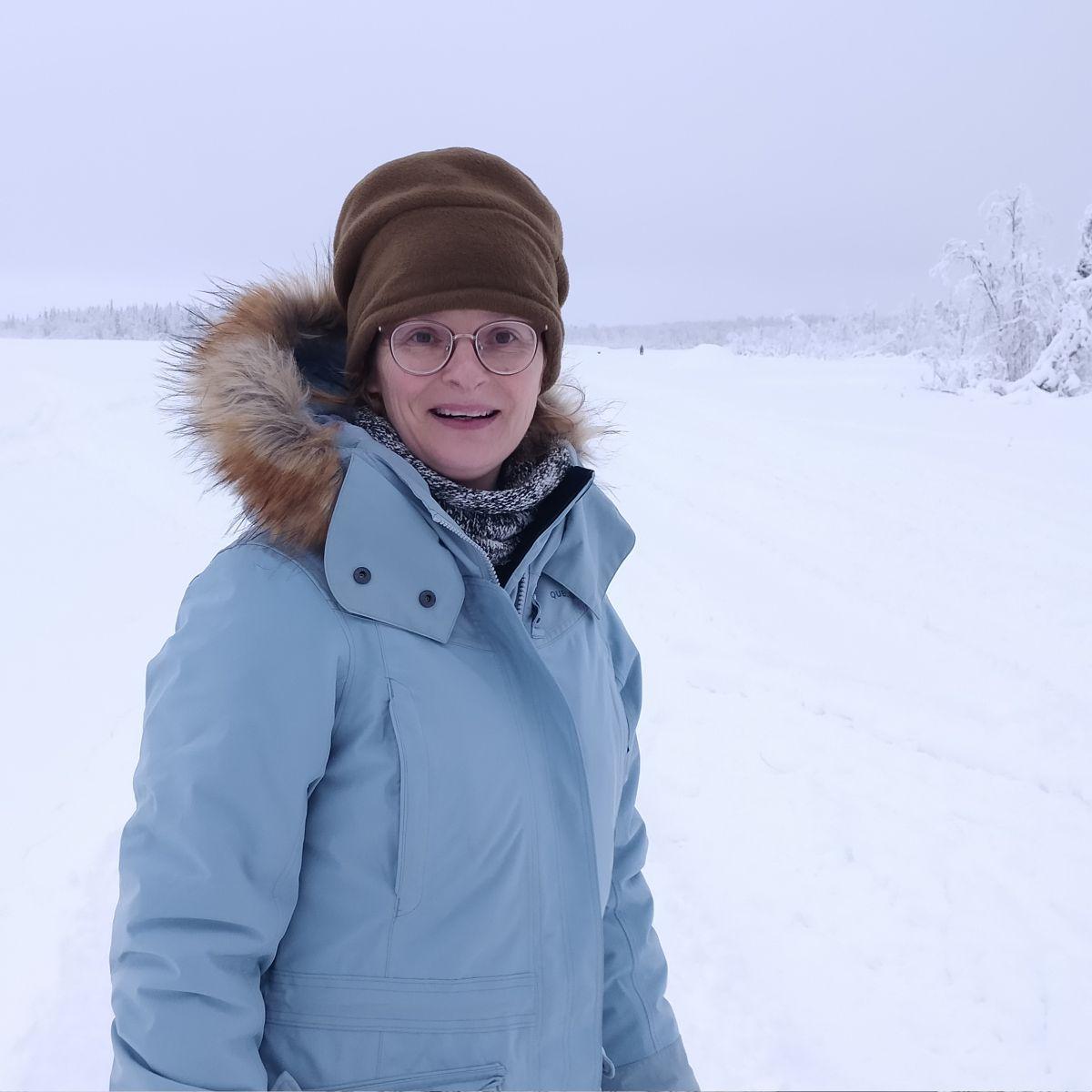 Belgian illustrator in winter clothing during polar night, Finnish Lapland